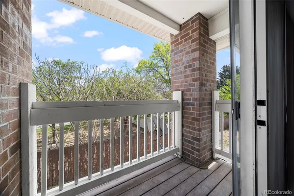 a view of a balcony with wooden floor