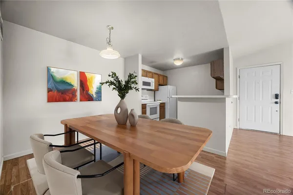 a view of a dining room with furniture and wooden floor