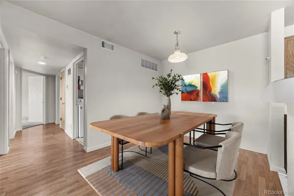 a view of a dining room with furniture wooden floor and chandelier
