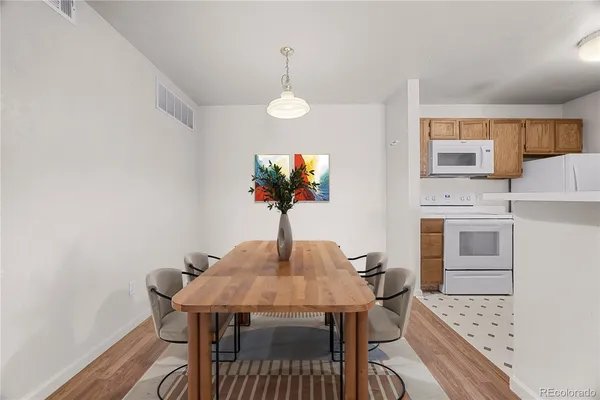a view of a dining room with furniture and wooden floor
