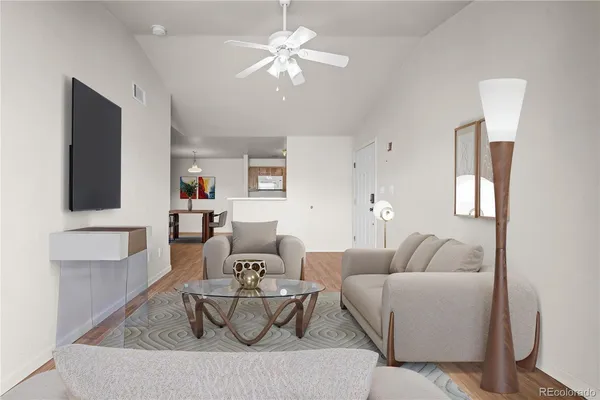 a living room with furniture and a chandelier