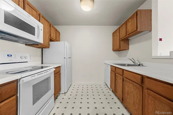 a kitchen with stainless steel appliances a stove a sink and a microwave