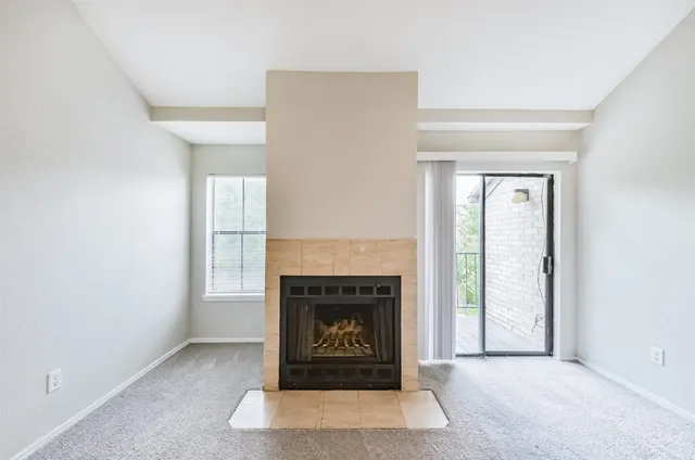 a view of a big room with chandelier fan and windows