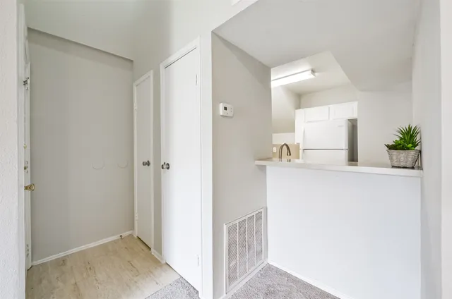 a kitchen with a sink cabinets stainless steel appliances and a window