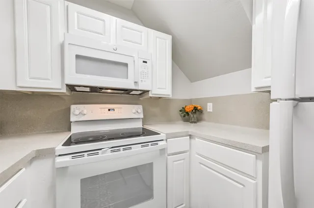 a view kitchen with a sink and refrigerator