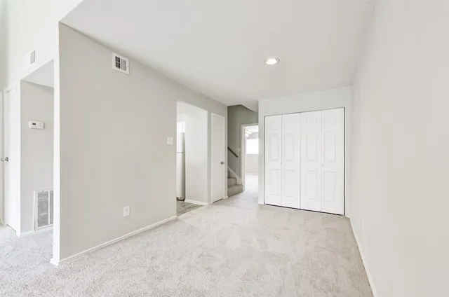 a view of empty room with a fireplace