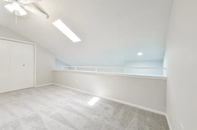 a view of an empty room with a fan