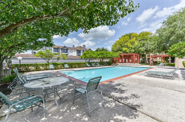 a view of a swimming pool with a patio