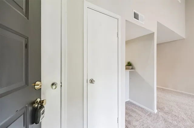 an empty room with fireplace and fan