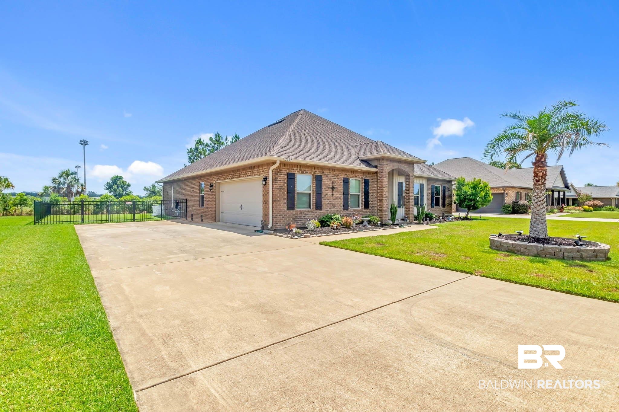 2049 Bourbon Street Foley, AL 36535 - Photo 5 of 56 French country style house featuring driveway, a garage, brick siding, and a shingled roof
