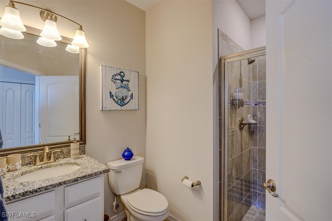 10655 Prato Drive Fort Myers, FL 33913 - Photo 33 of 49 a bathroom with a granite countertop sink toilet and shower