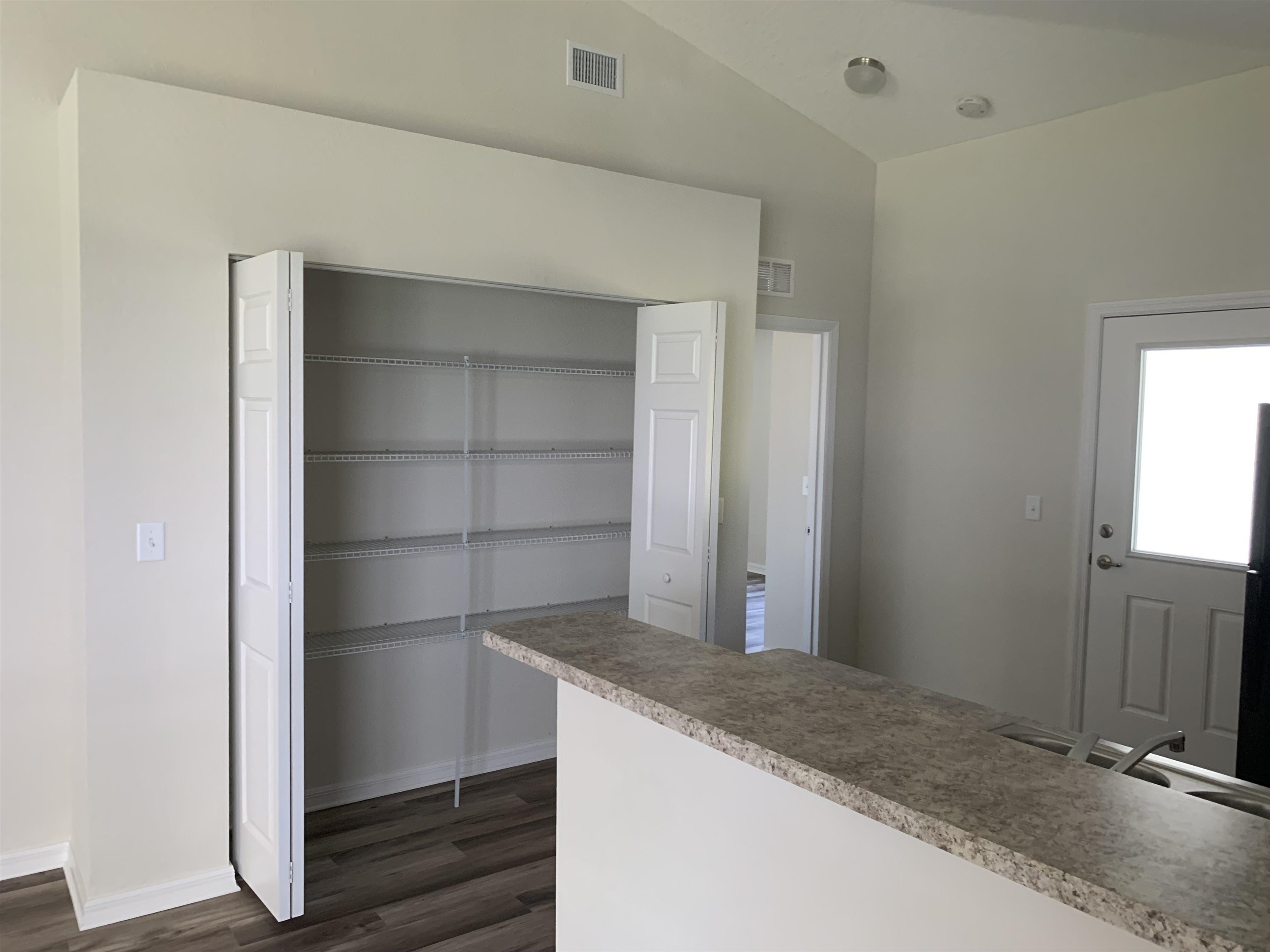 156 Gilbert Street St. Augustine, FL 32084 - Photo 14 of 35 a view of an empty room and wooden floor