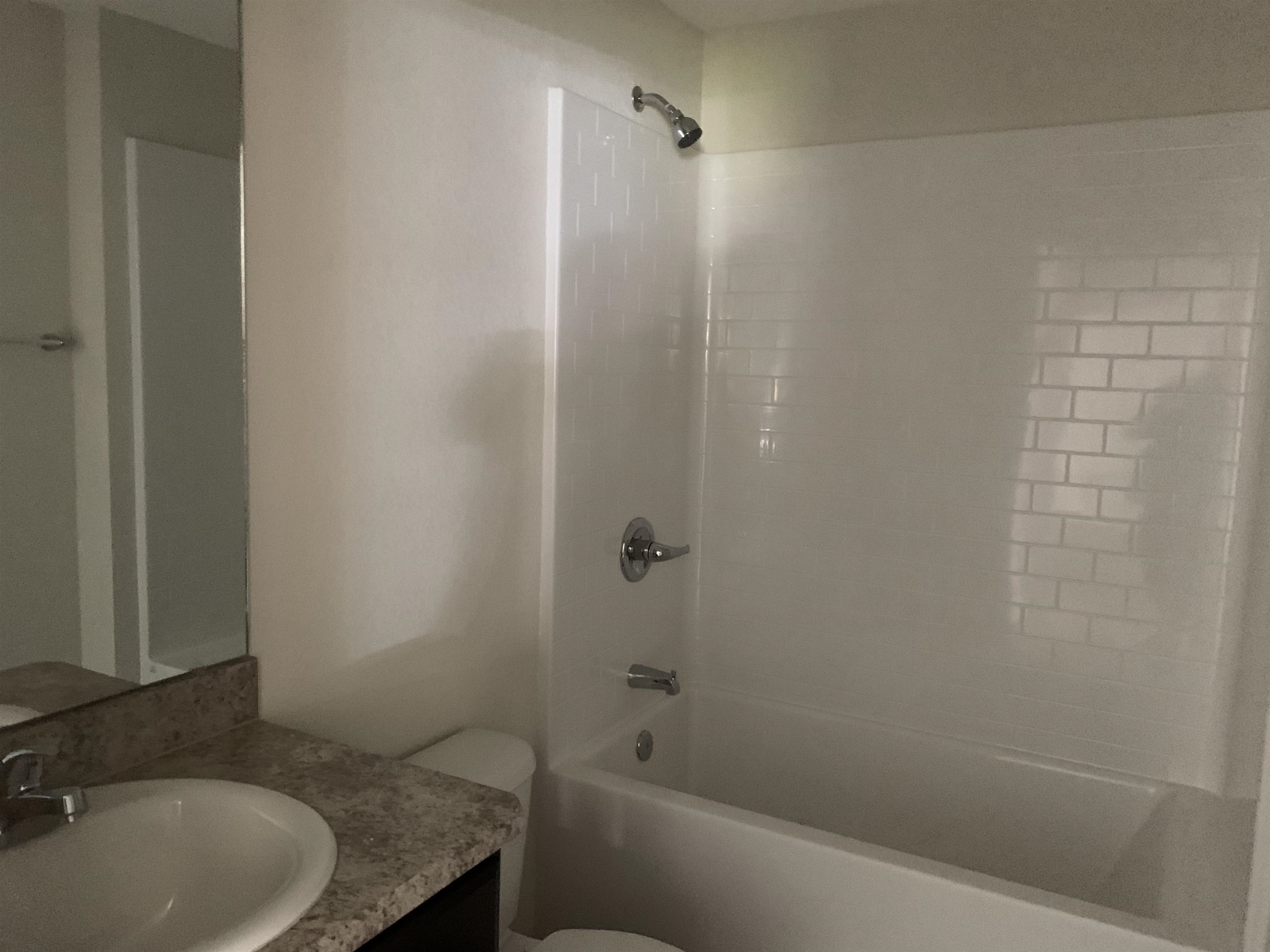 156 Gilbert Street St. Augustine, FL 32084 - Photo 27 of 35 a bathroom with a granite countertop bathtub shower and toilet