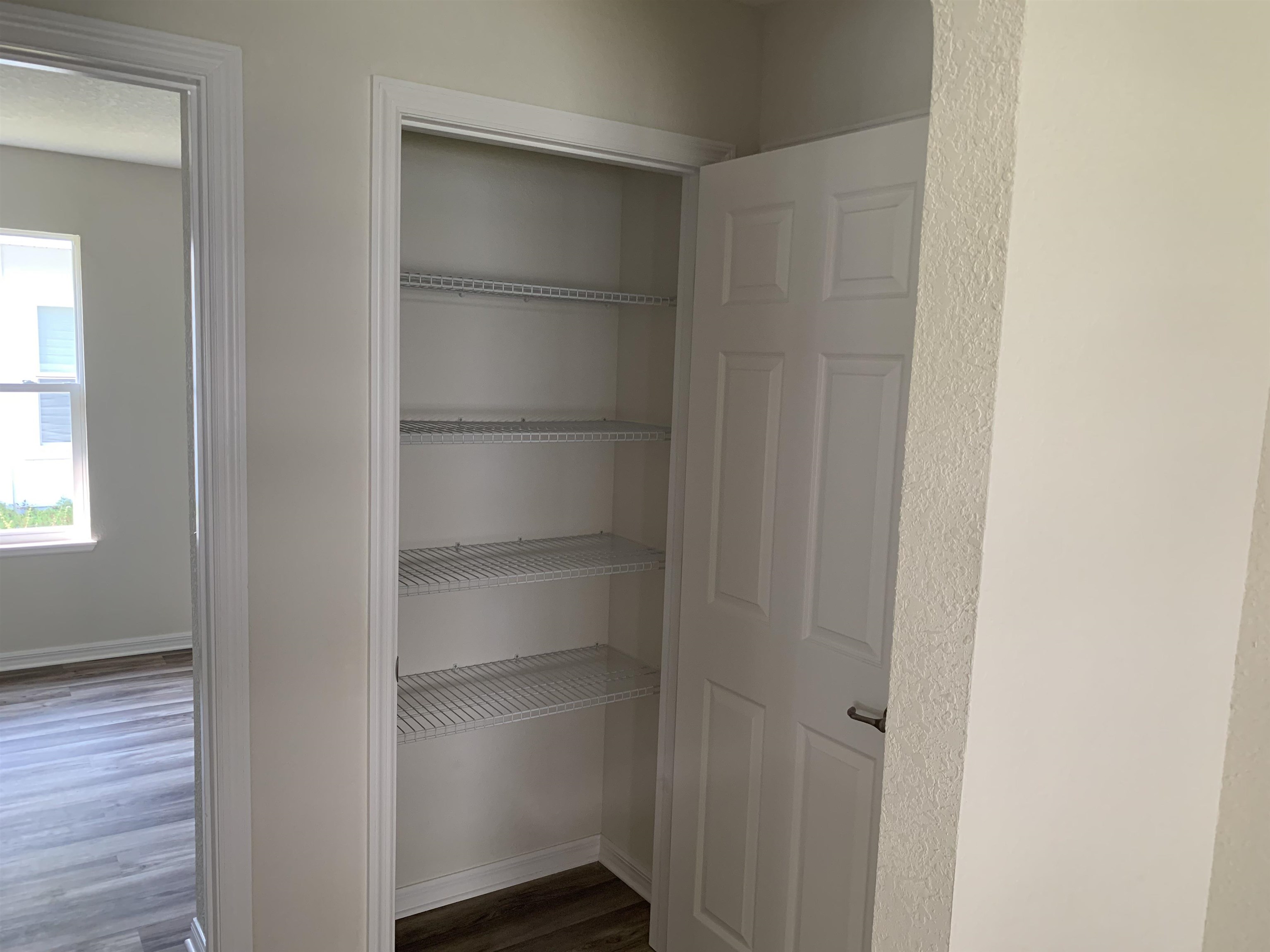 156 Gilbert Street St. Augustine, FL 32084 - Photo 28 of 35 a view of walk in closet with empty racks