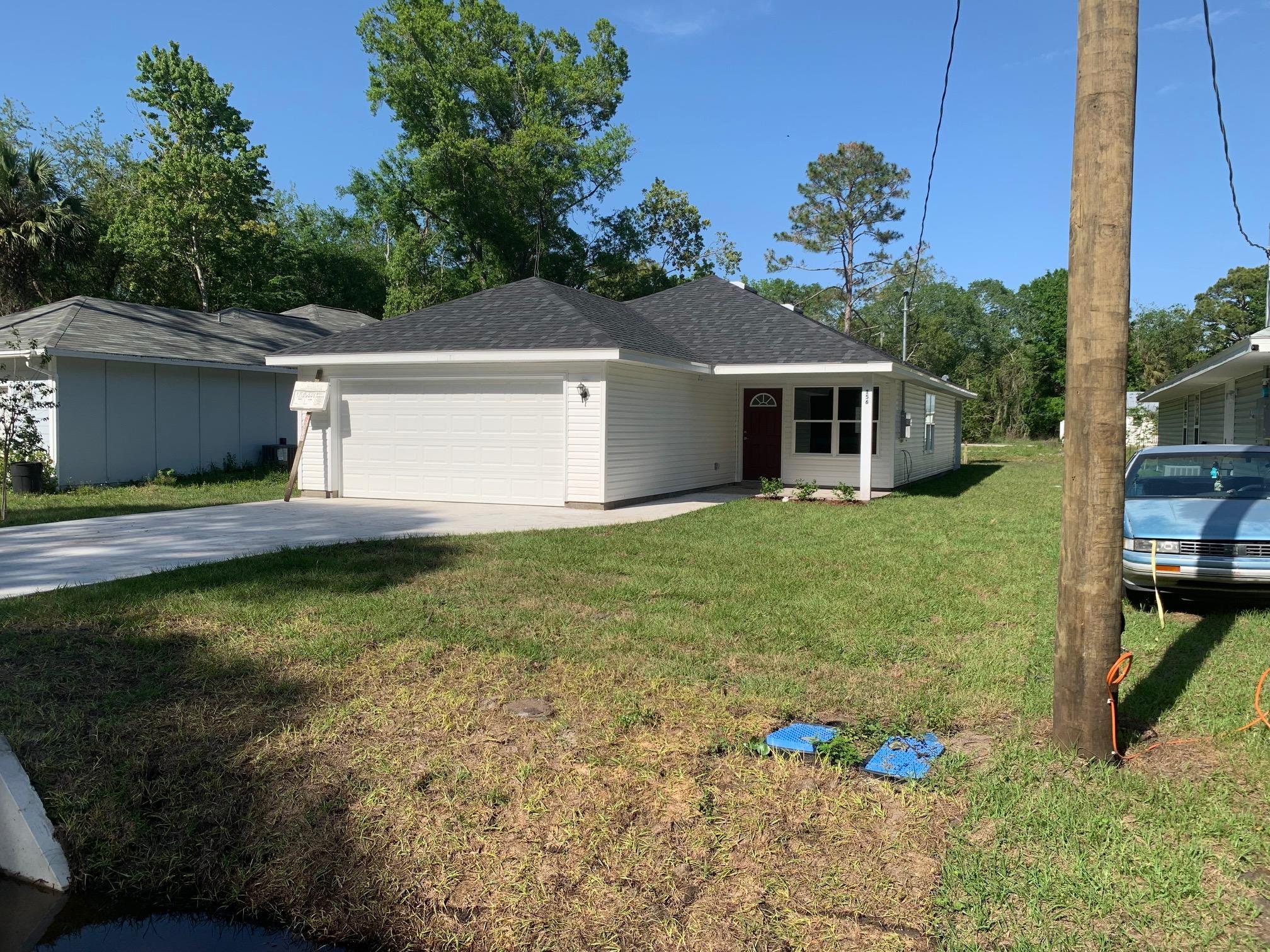 156 Gilbert Street St. Augustine, FL 32084 - Photo 5 of 35 a front view of house with yard and trees in the background