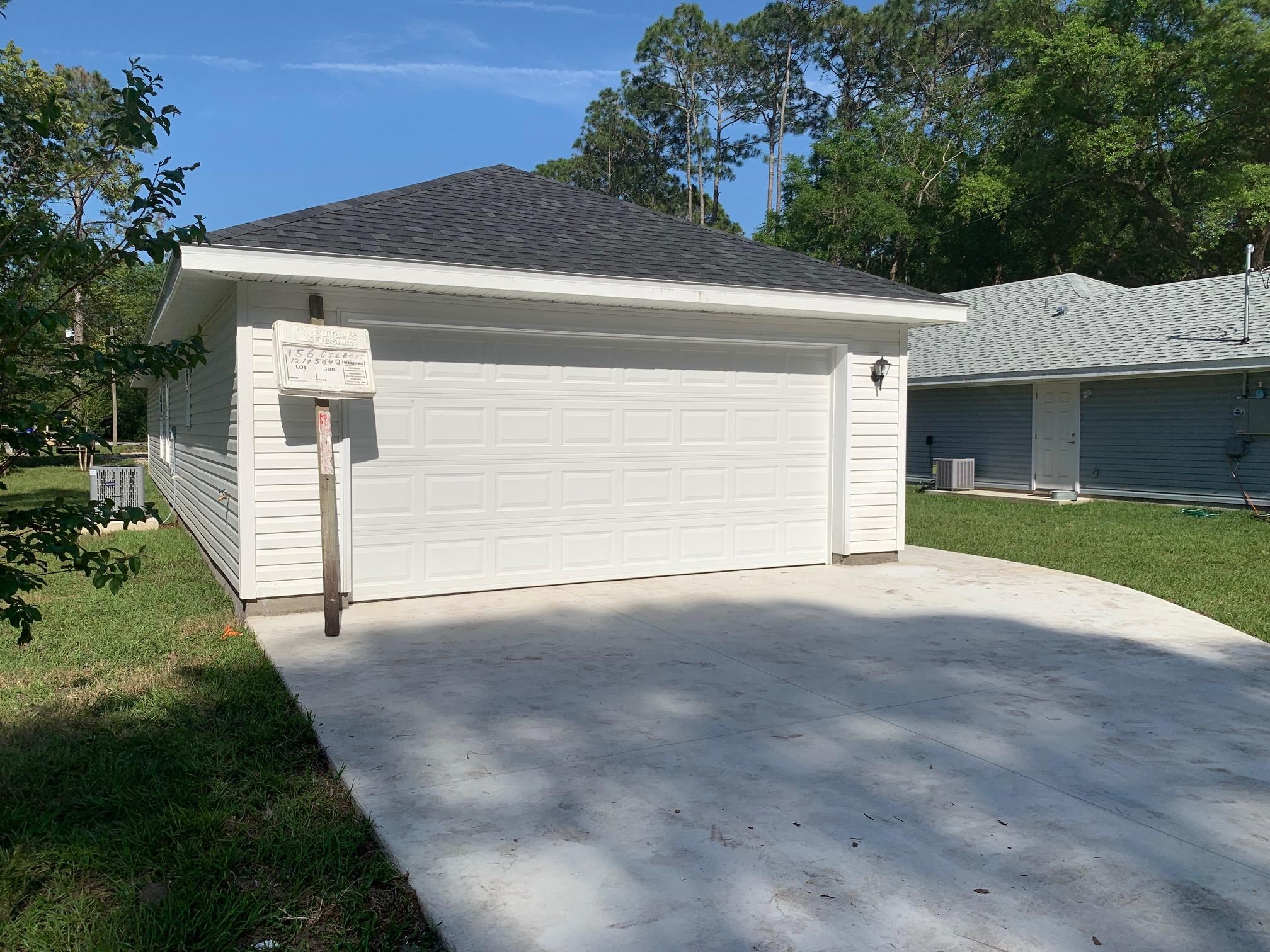 156 Gilbert Street St. Augustine, FL 32084 - Photo 6 of 35 a front view of a house with a yard and garage
