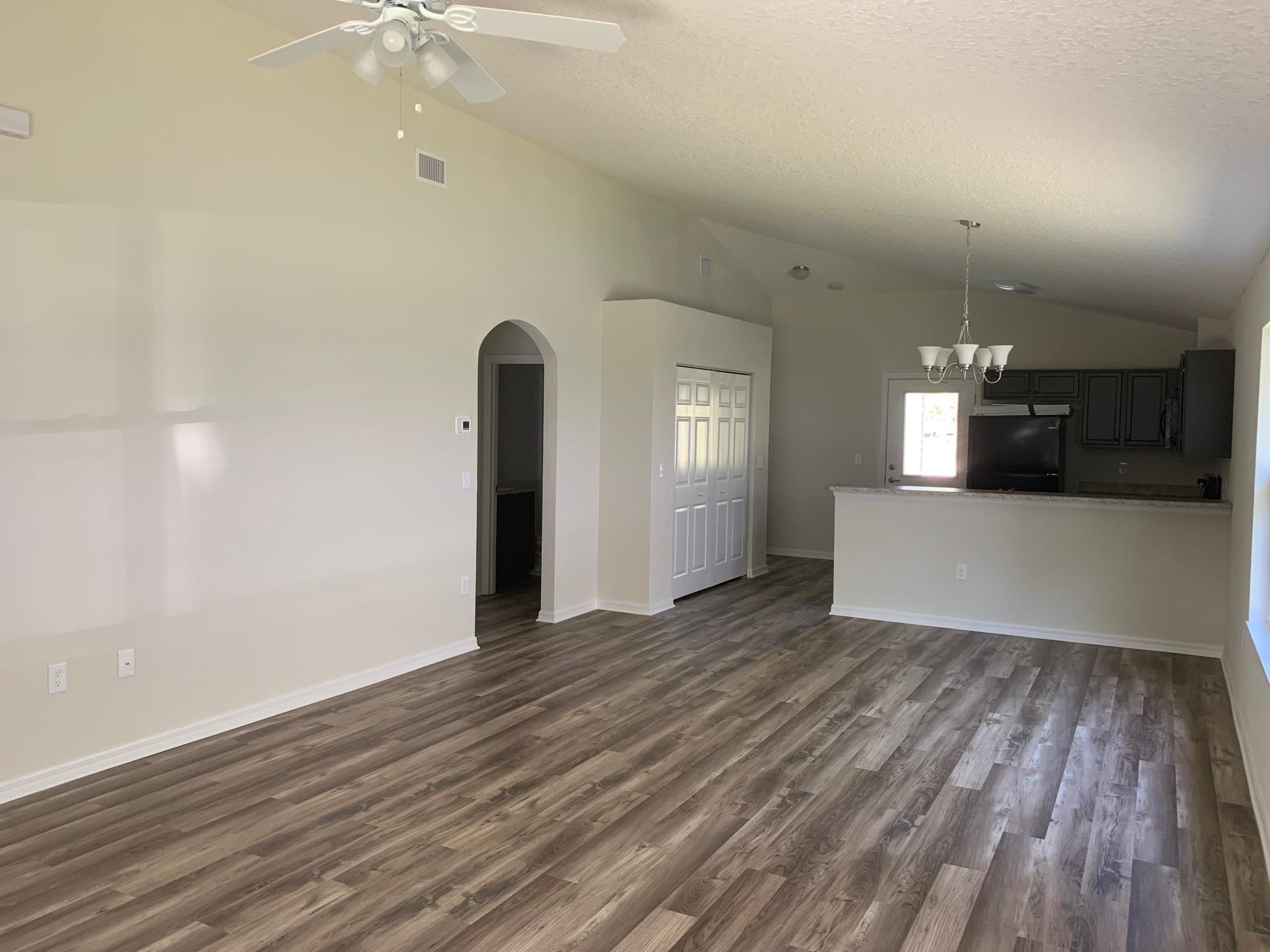 156 Gilbert Street St. Augustine, FL 32084 - Photo 10 of 35 an empty room with wooden floor and windows