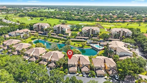 an aerial view of residential houses with outdoor space and swimming pool