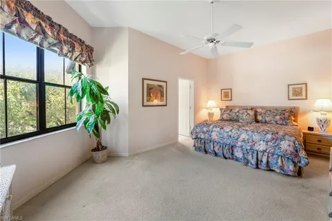 a bedroom with a bed and a potted plant
