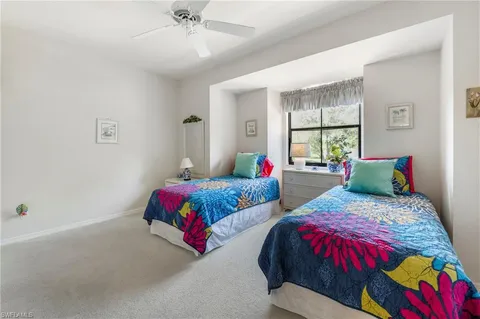 a bedroom with two beds and a window