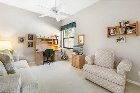 a living room with furniture a couch and a chandelier