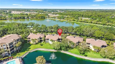 an aerial view of a house with a lake view