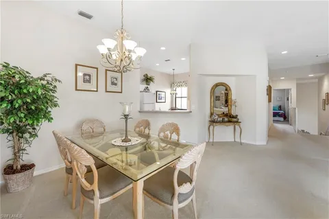 a view of a dining room with furniture and chandelier