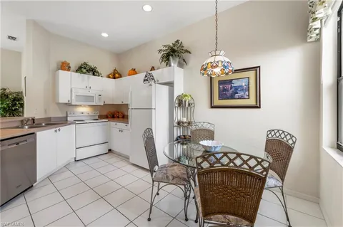 a kitchen with stainless steel appliances granite countertop a refrigerator sink and cabinets