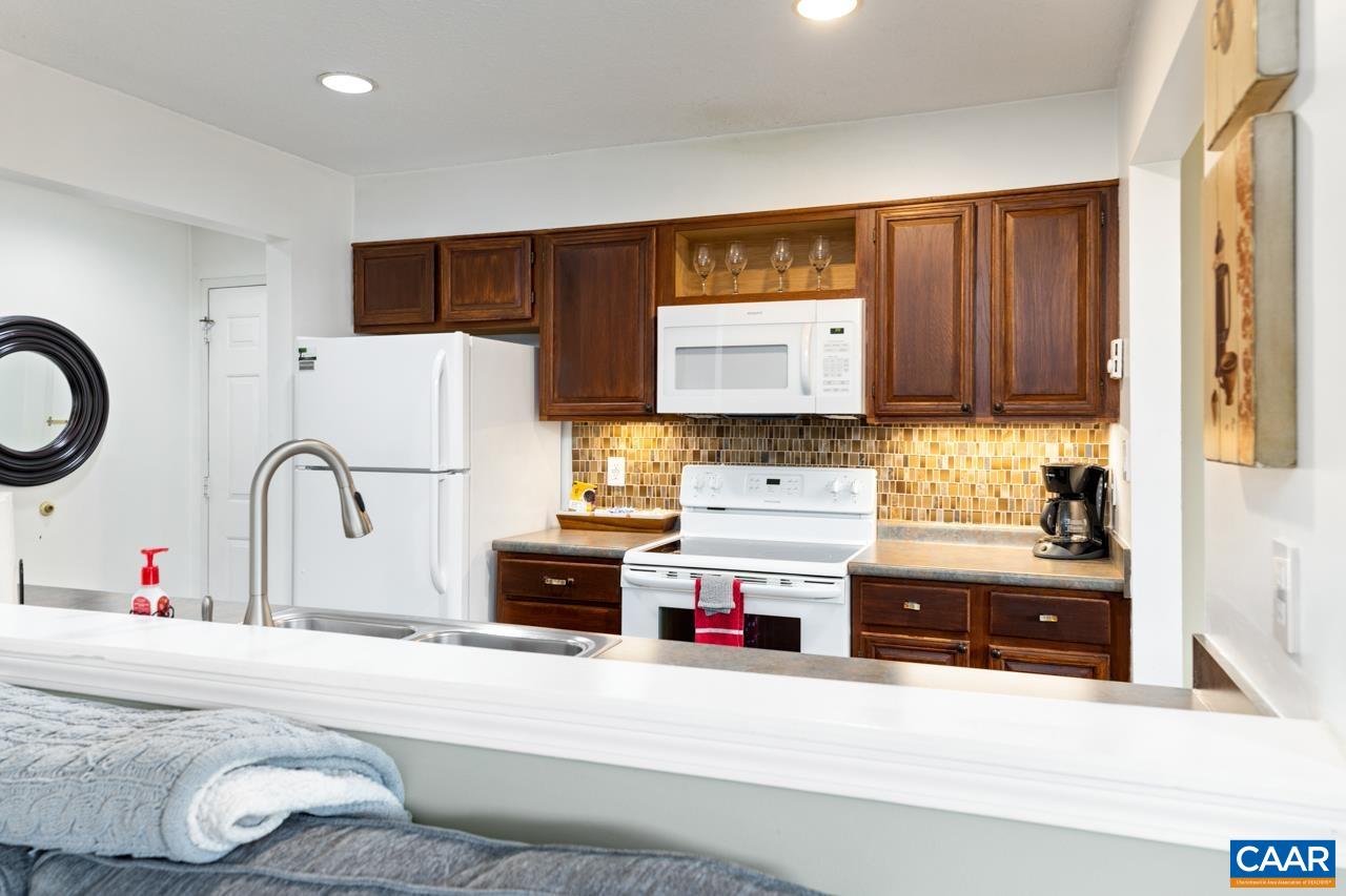 2029 Stone Ridge Wintergreen, VA 22967 - Photo 11 of 30 a kitchen with stainless steel appliances a stove a sink and a refrigerator with wooden floor
