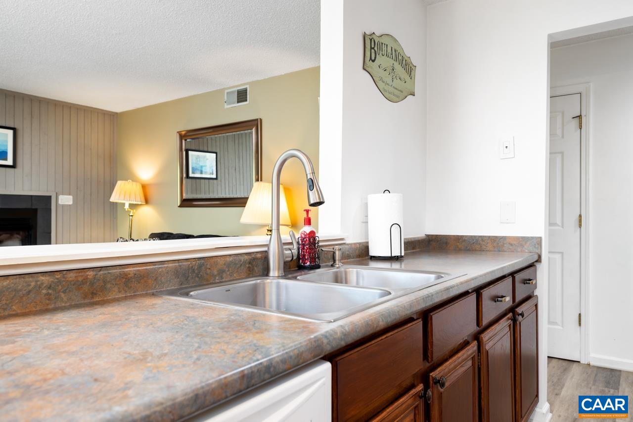 2029 Stone Ridge Wintergreen, VA 22967 - Photo 13 of 30 a kitchen with granite countertop a sink and a wooden floor