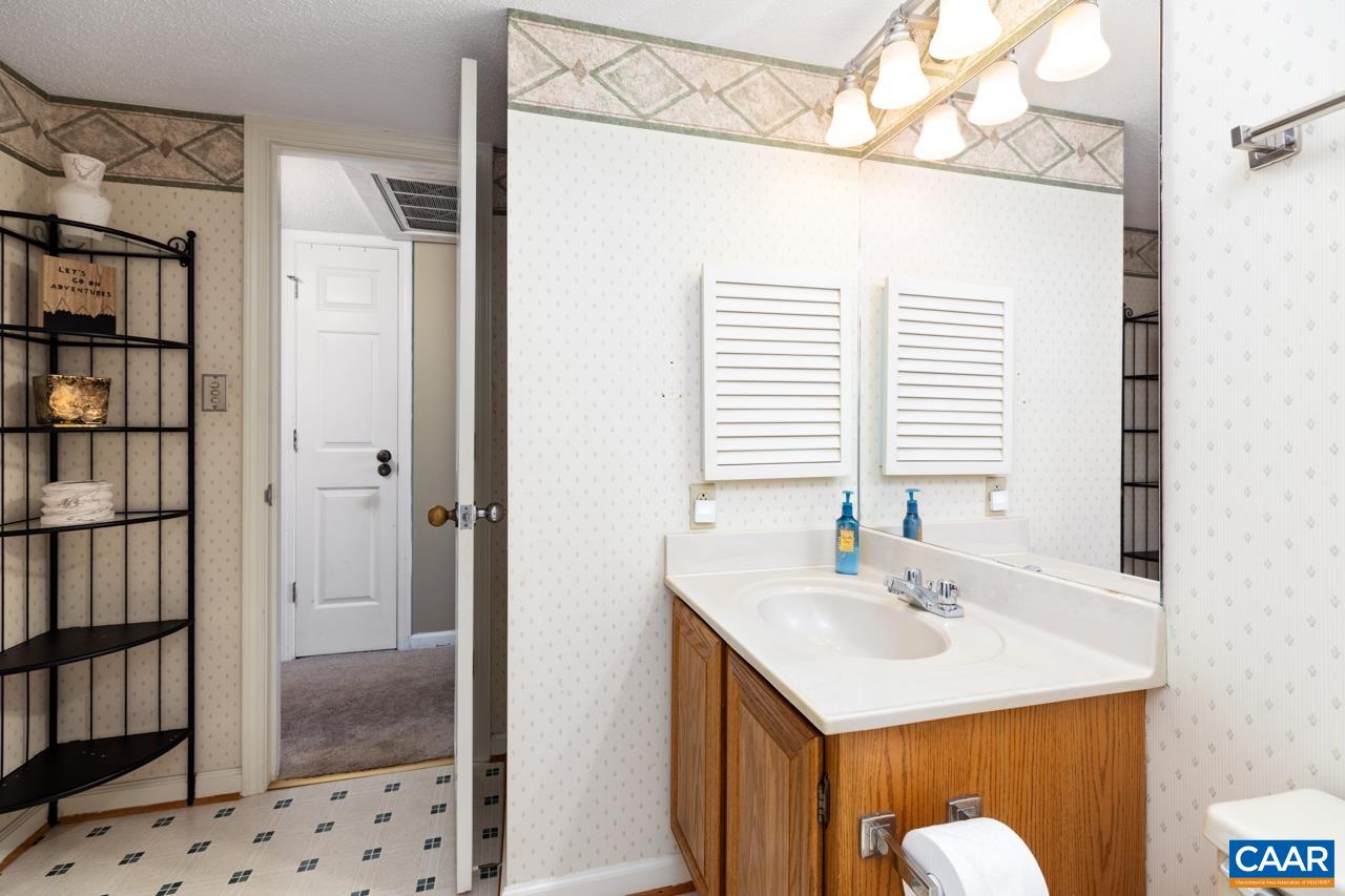 2029 Stone Ridge Wintergreen, VA 22967 - Photo 24 of 30 a bathroom with a sink and a mirror