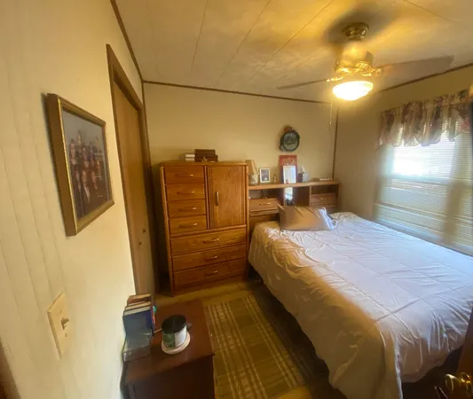 a bed room with a bed and a mirror