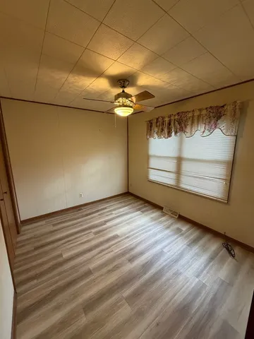 a view of a room with wooden floor