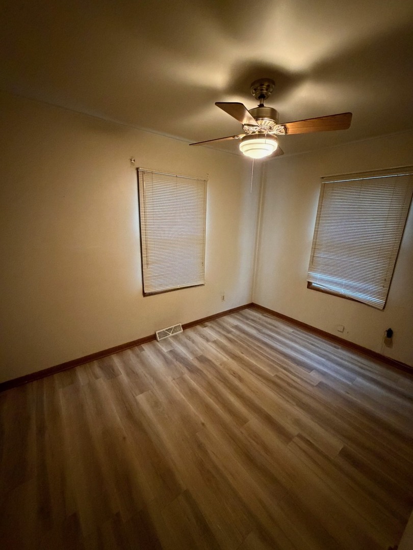 23 West 143rd Street Dixmoor, IL 60426 - Photo 26 of 30 wooden floor in an empty room