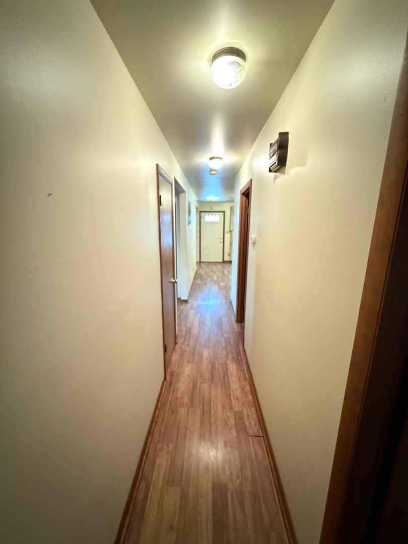 23 West 143rd Street Dixmoor, IL 60426 - Photo 30 of 30 a view of a hallway with wooden floor