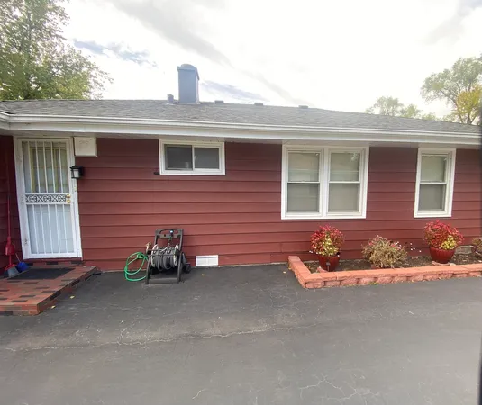 a front view of a house with sitting area
