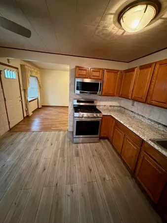 a kitchen with wooden floors and a stove
