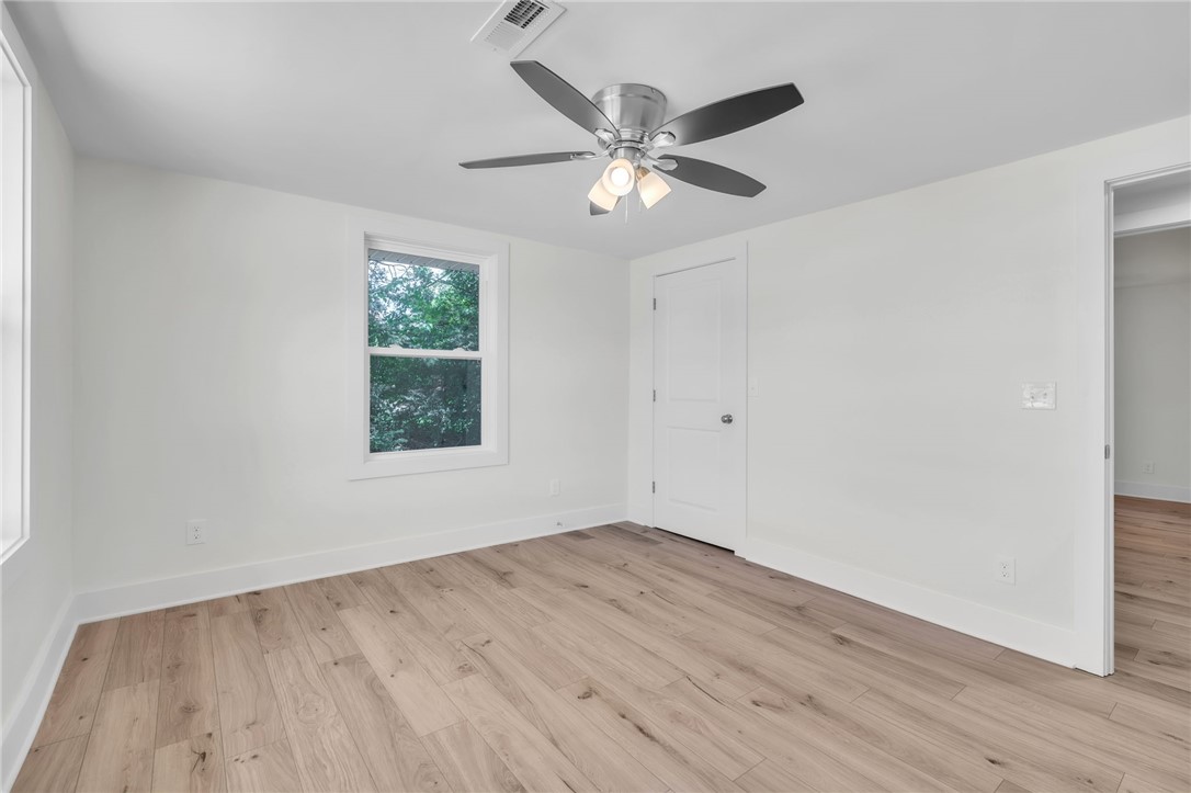 7 Beaverdam Road Williamston, SC 29697 - Photo 18 of 27 LVP flooring and a ceiling fan create a comfortable atmosphere in this inviting space.