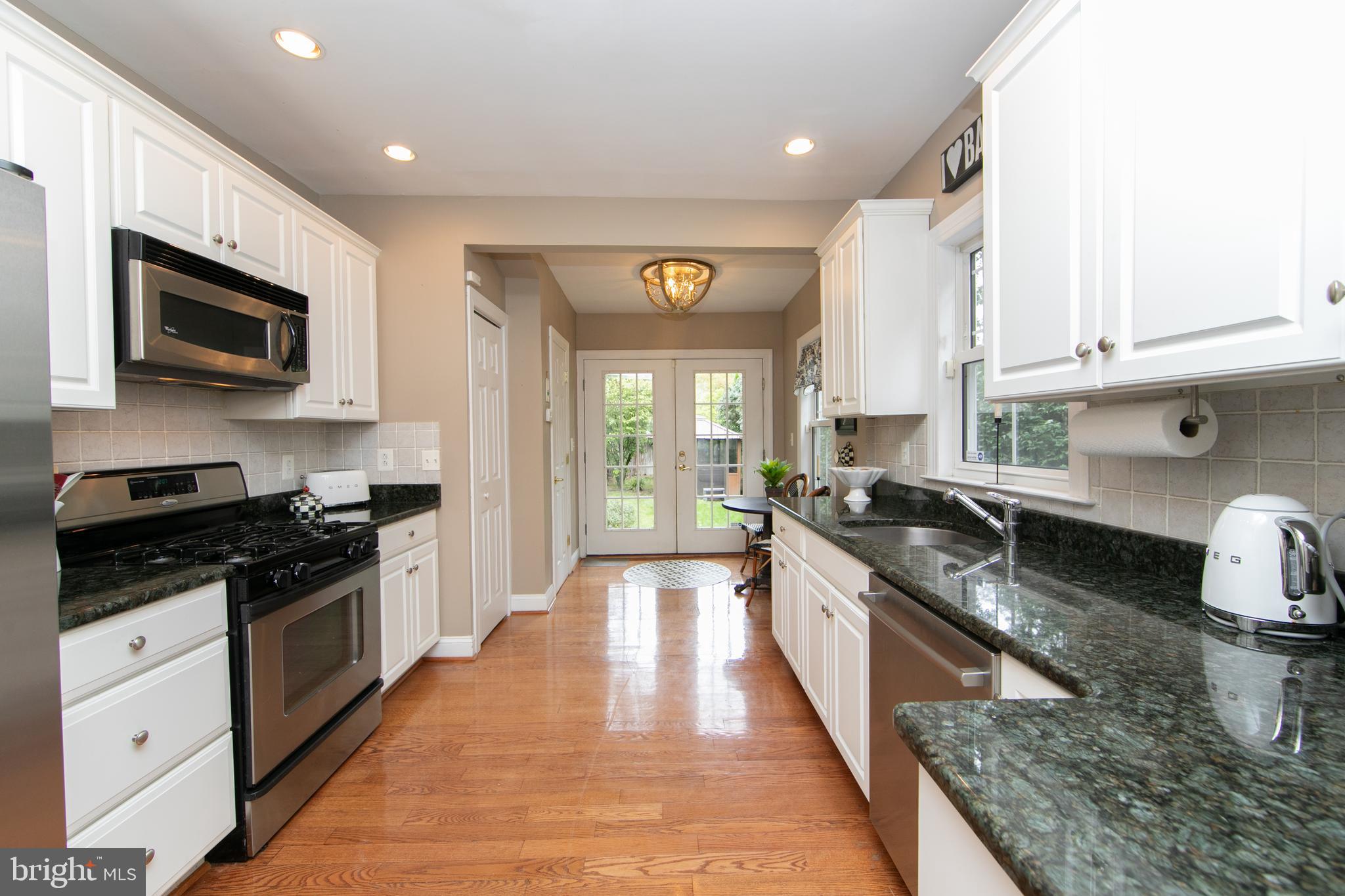 107 Centre Street Haddonfield, NJ 08033 - Photo 17 of 45 a large kitchen with granite countertop lots of counter space and stainless steel appliances