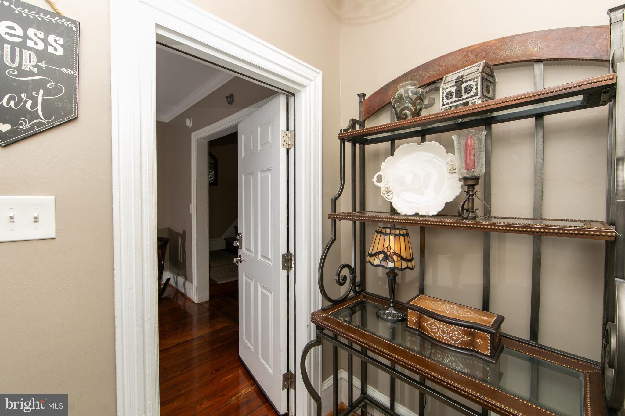 107 Centre Street Haddonfield, NJ 08033 - Photo 6 of 45 a view of a hallway with wooden floor and stairs