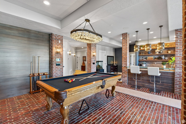 12308 Mariah Circle Draper, UT 84020 - Photo 99 of 293 Entertainment room featuring brick flooring, a built-in bar with wood-finish paneling, and a pool table