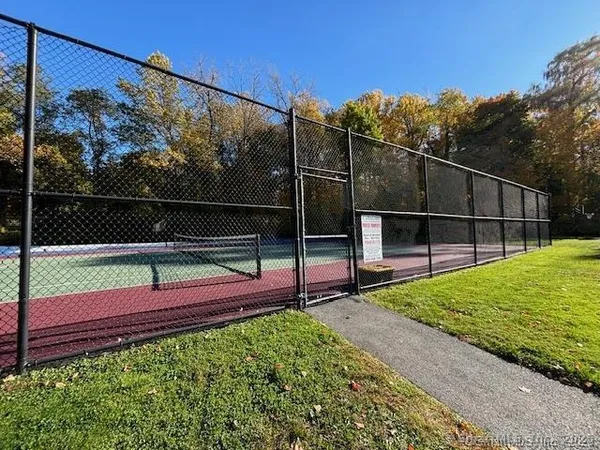 a view of a large building with a big yard and large trees