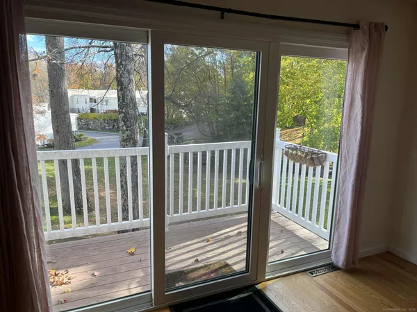 a view of a porch with a floor to ceiling window