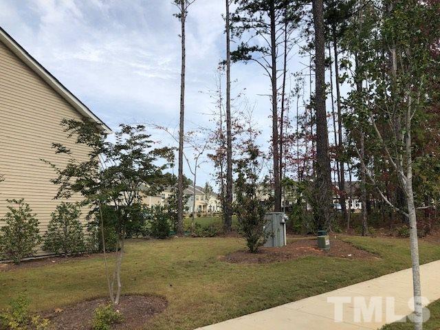 6000 Beale Loop Raleigh, NC 27616 - Photo 14 of 16 a backyard of a house with lots of green space