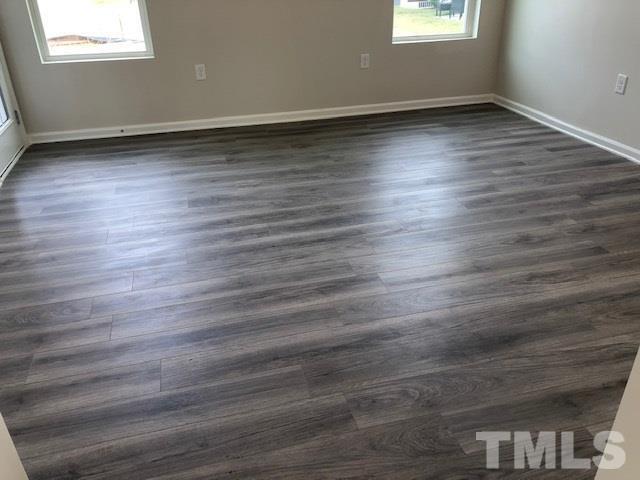 6000 Beale Loop Raleigh, NC 27616 - Photo 4 of 16 an empty room with wooden floor and windows
