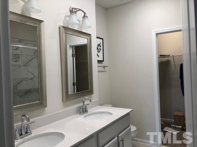 6000 Beale Loop Raleigh, NC 27616 - Photo 9 of 16 a bathroom with a sink vanity and a mirror
