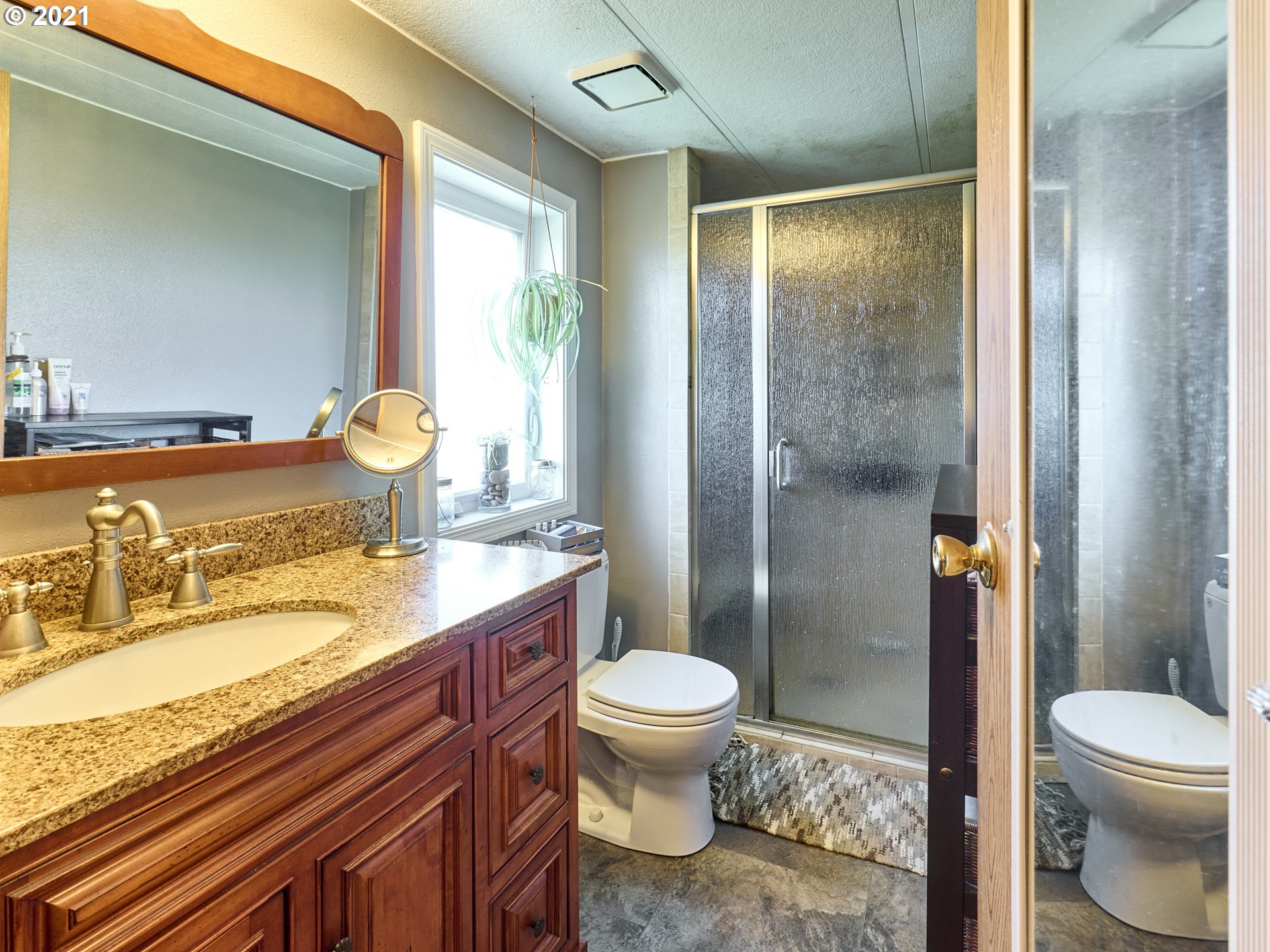913 Toliver Road, Unit B Molalla, OR 97038 - Photo 13 of 26 a bathroom with a granite countertop sink toilet and shower