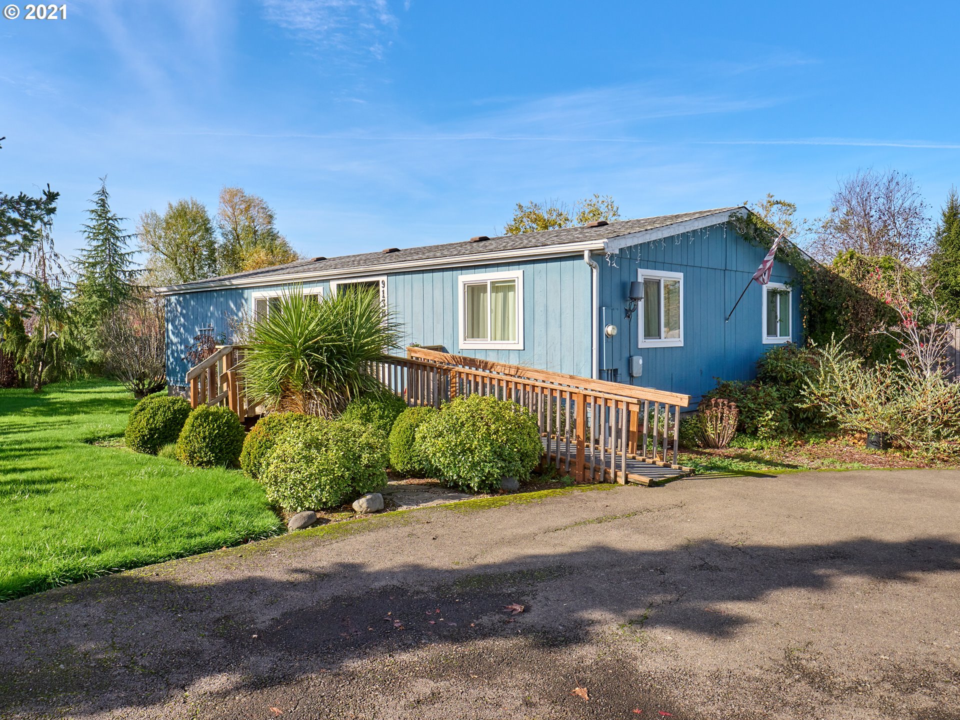 913 Toliver Road, Unit B Molalla, OR 97038 - Photo 20 of 26 a front view of a house with a yard and potted plants