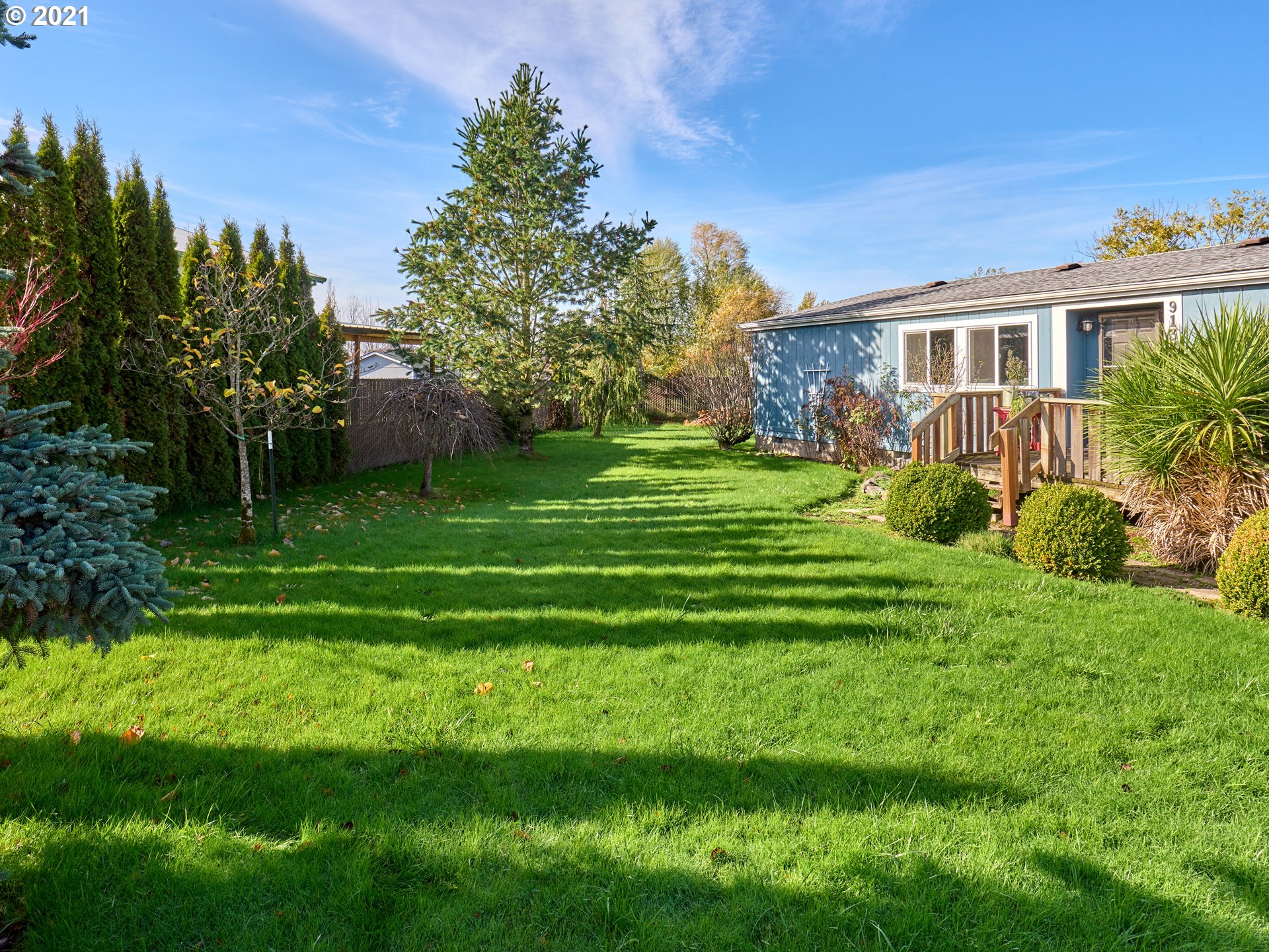 913 Toliver Road, Unit B Molalla, OR 97038 - Photo 22 of 26 a front view of a house with a yard table and chairs
