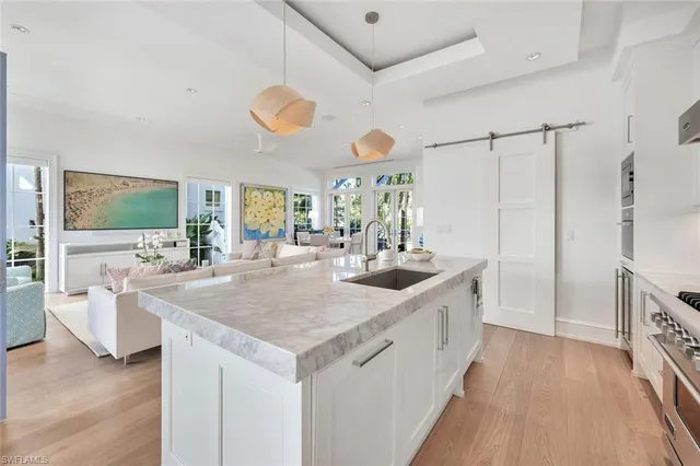 a kitchen with stainless steel appliances granite countertop a sink and a stove